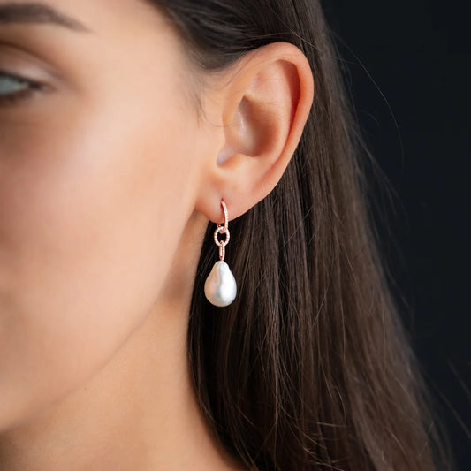 woman wearing ANNA earring hoop and pendant with diamonds and white pearl in rose gold