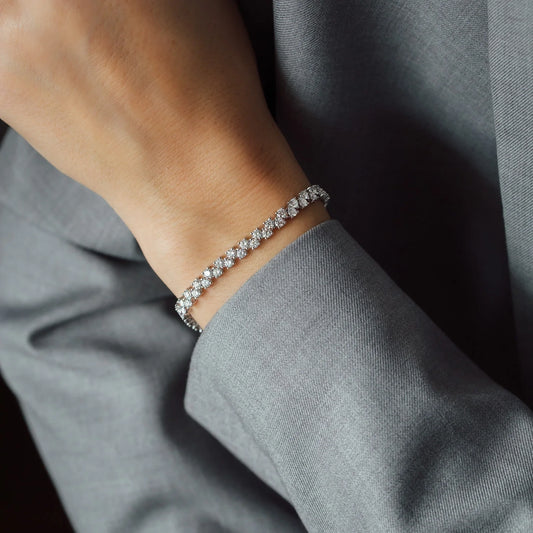 outfit detail with hand wearing white gold diamond bracelet