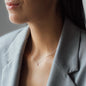 cleavage of woman in grey blazer with necklace SOUL with white diamond in white gold