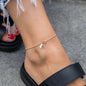 anklet sam petite in 18 KT rose gold worn on ankle with little gold tag with engraving