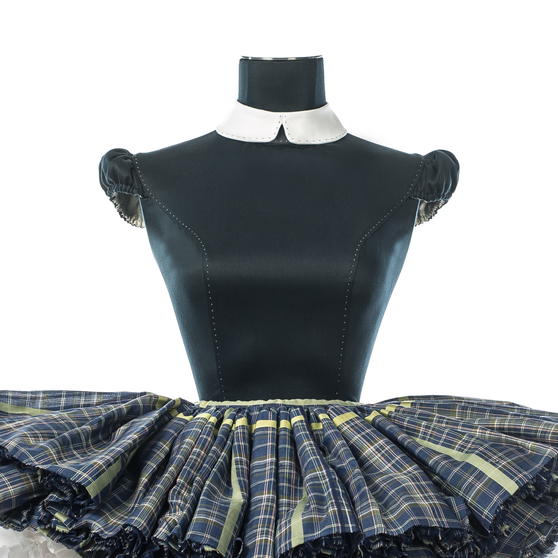 Close up of Anna Doll in blue with checkered skirt front view