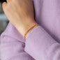 Bracelet Jackson with chain links in 18 KT rose gold worn on wrist of person in lilac sweater