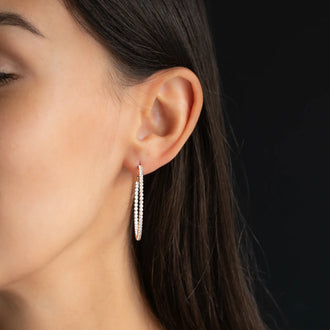 hoop earring CHLOE 40mm with white diamonds in 18 kt rose gold worn on womans ear