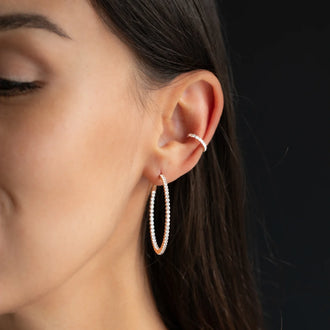 hoop earring CHLOE 40mm and ear cuff CHLOE with white diamonds in 18 kt rose gold worn on womans ear