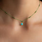 close up of green necklace with 18 KT yellow gold square pendant with precious stone turquoise