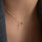 close up of ANNA Necklace gianna in 18 kt rose gold with green gemstone worn around neck