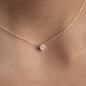 close up of ANNA necklace Isabelle in 18 kt rose gold with white diamond pendant worn