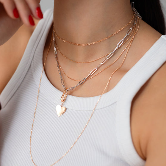 woman wearing ANNA Necklace layering in white gold and rose gold