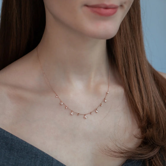Woman wearing necklace leona in rose gold with white diamonds