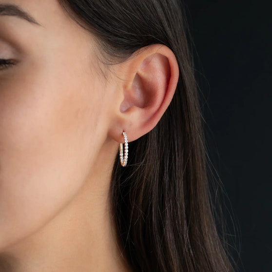 hoop earring CHLOE 20mm with white diamonds in 18 kt rose gold worn on womans ear