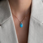 Pendant CIARA in Sterling Silver with big turquoise gemstone, diamonds and cross pendant worn on womans necklace