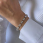 movement of woman wearing bracelet with white diamonds 