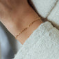 yellow gold bracelet on womans wrist