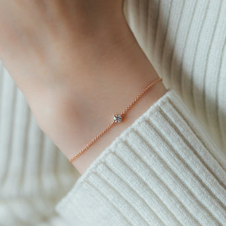 close up of bracelet SOUL in rose gold with white diamond on womans wrist
