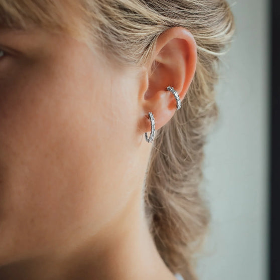 Woman wearing Ear Cuff and Earring JOLIE with white diamonds and in white gold
