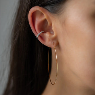Womans ear with rose gold earring and ear cuff Claire in white gold