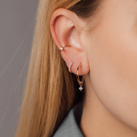 close up of woman with ear cuff and pendant soul in rose gold and hoops in rose gold with white diamonds