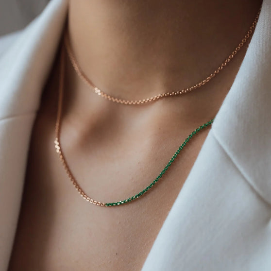 close up of necklace Nala in rose gold with green details worn from woman