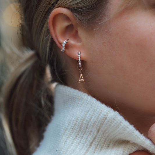 blond woman wearing diamond earrings