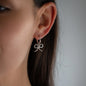 Pendant DAISY in silver worn on hoop earring