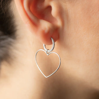 close up of ear with earring and heart pendant Emotion in sterling silver