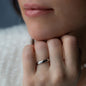 woman whit chin on hand wearing white gold wedding ring