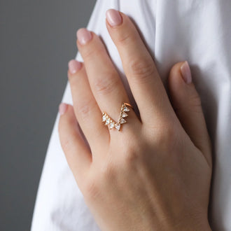 Ring Iconic in rose gold with white diamonds worn on womans hand