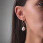 woman closeup ear and earring with pearl pendant