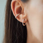 detail of Woman wearing white diamond Earring Jolie in size 15mm in rose gold