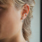 woman wearing earring jolie in size 20mm with white diamonds in white gold