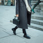 woman walking with black ellen bag